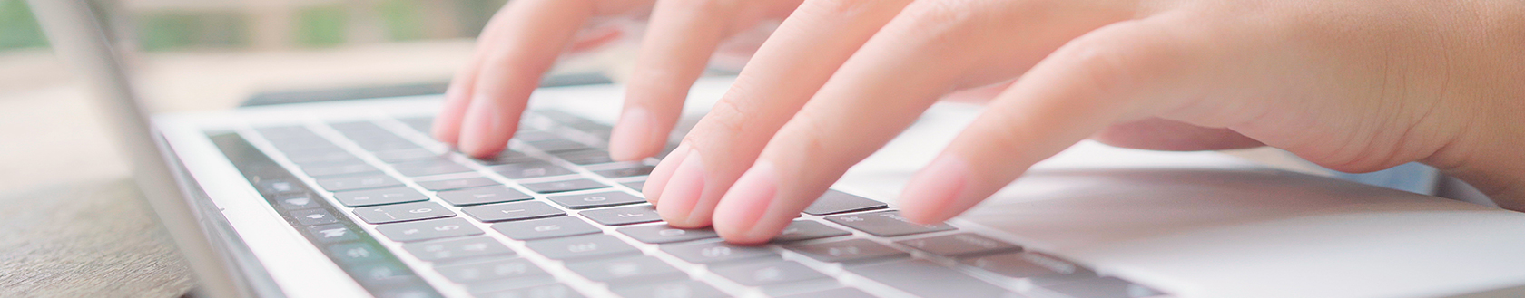 A Person Typing on a Laptop